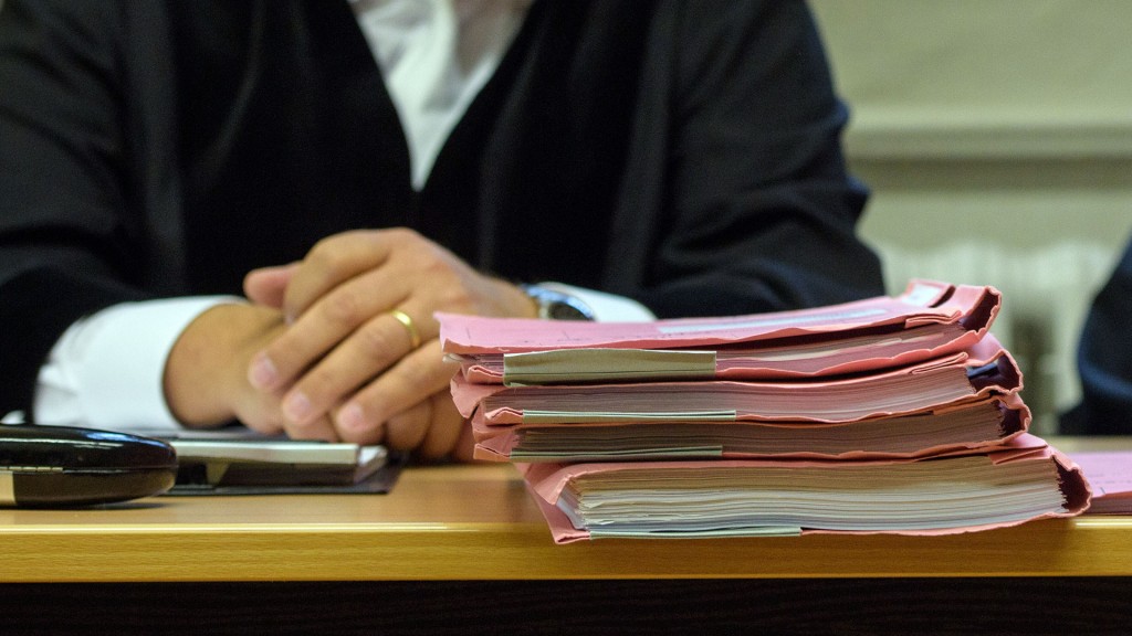 Symbolbild: ein Richter sitzt hinter einem Stapel Aktenmappen